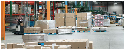 A Spacious Warehouse Filled with Stacked Boxes and Pallets